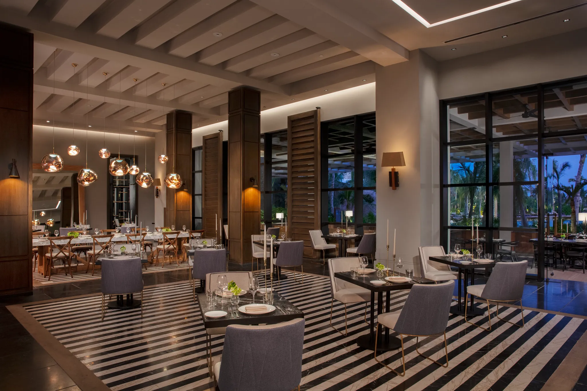 Allora Italian restaurant at Secrets Moxché Playa del Carmen featuring elegant dining tables, warm pendant lighting, and modern coastal-inspired décor.