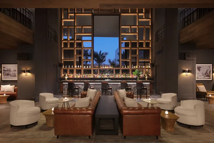 Dark Horse Sports Bar at Secrets Moxché Playa del Carmen featuring a stylish lounge bar, leather seating, and large screens for watching sports.