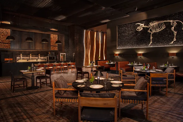 Ember Fire Kitchen at Secrets Moxché Playa del Carmen featuring a stylish steakhouse-style dining room with open-fire grill cuisine and warm ambient lighting.