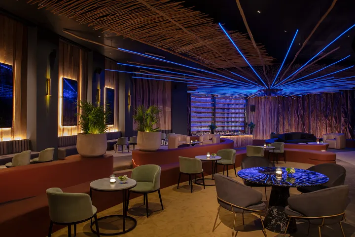 Gypsy Music Lounge Bar at Secrets Moxché Playa del Carmen featuring a stylish nightclub lounge with neon lighting, DJ booth, and modern seating.