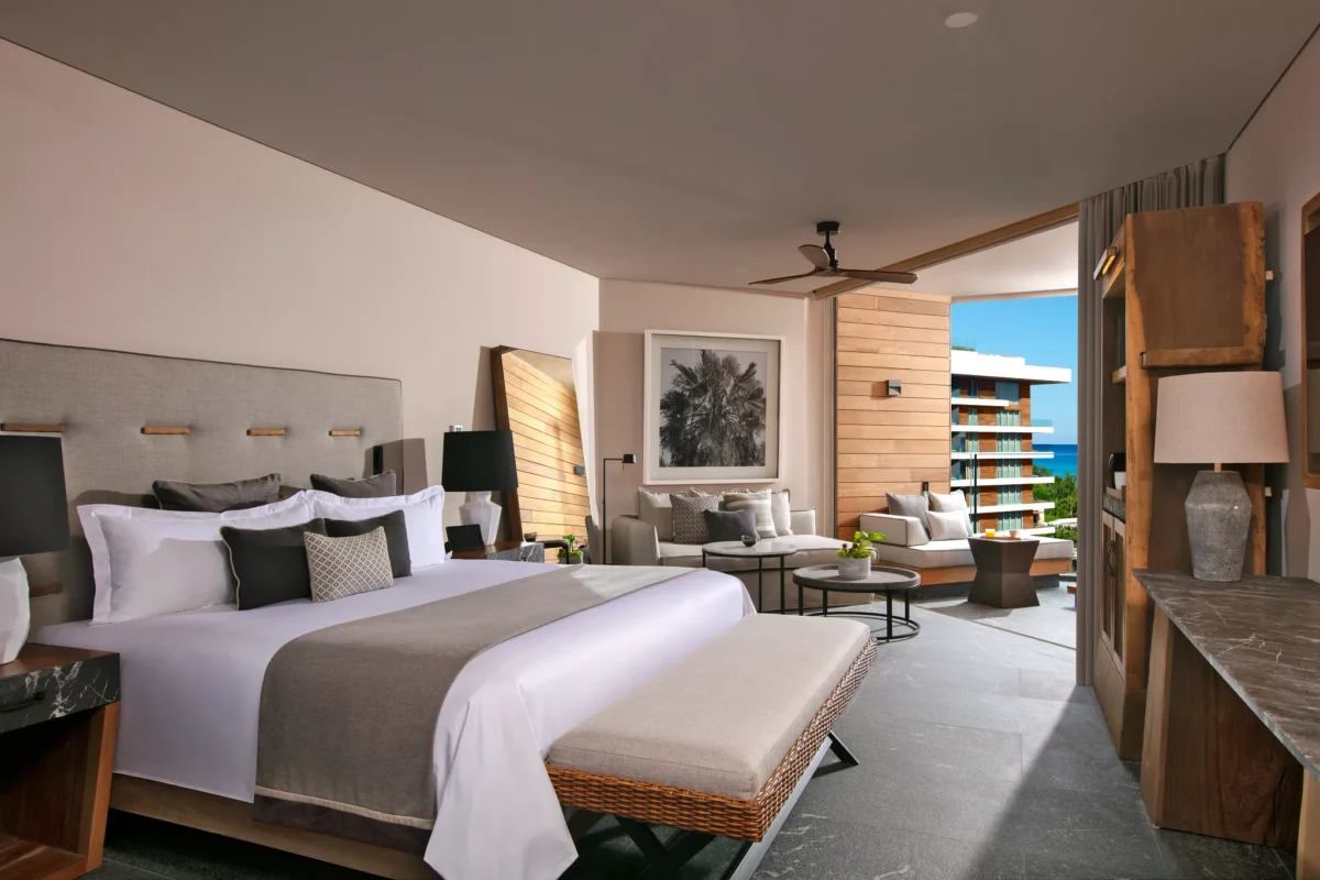 Junior Suite Ocean View with king bed, sitting area, and private terrace overlooking the Caribbean at Secrets Moxché Playa del Carmen.