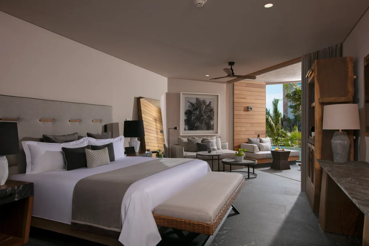 Junior Suite Tropical View with king bed, living area, and terrace at Secrets Moxché Playa del Carmen.