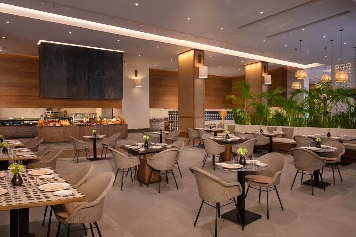 Market Café buffet restaurant at Secrets Moxché Playa del Carmen featuring modern dining tables and an international buffet station.