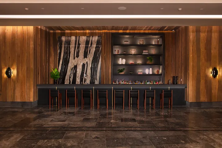 Moxché Lobby Bar at Secrets Moxché Playa del Carmen featuring a stylish wood-accented bar with modern seating in the resort lobby.