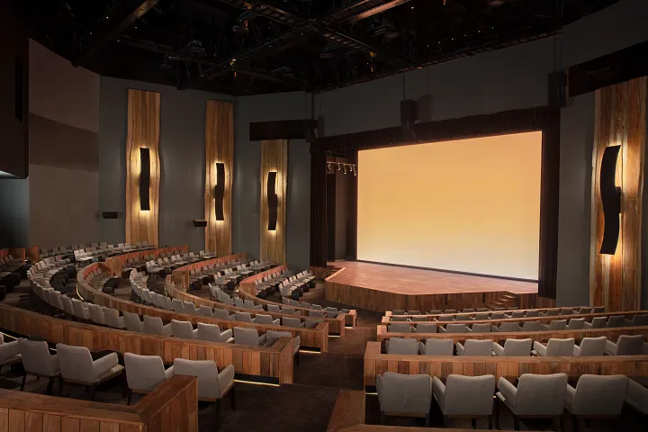Moxché Theatre at Secrets Moxché Playa del Carmen featuring a modern resort theater with tiered seating and a large stage for nightly entertainment.