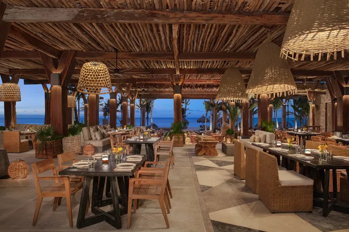 Seasoul seafood restaurant at Secrets Moxché Playa del Carmen featuring an open-air oceanfront dining terrace with wooden décor and Caribbean views.