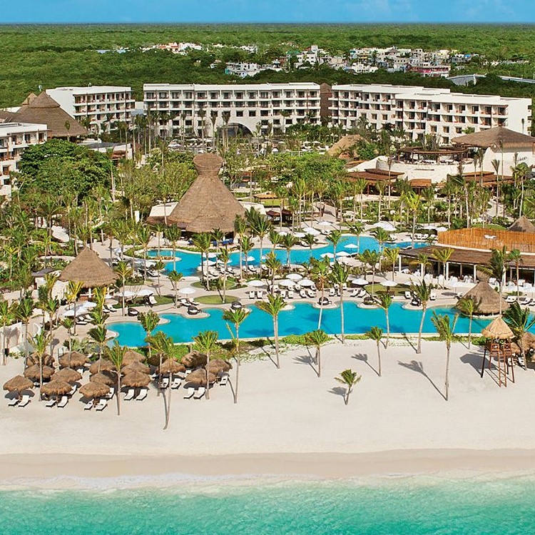 Secrets Akumal Riviera Maya adults-only all-inclusive resort with beachfront pools, tropical gardens, and secluded bay setting.