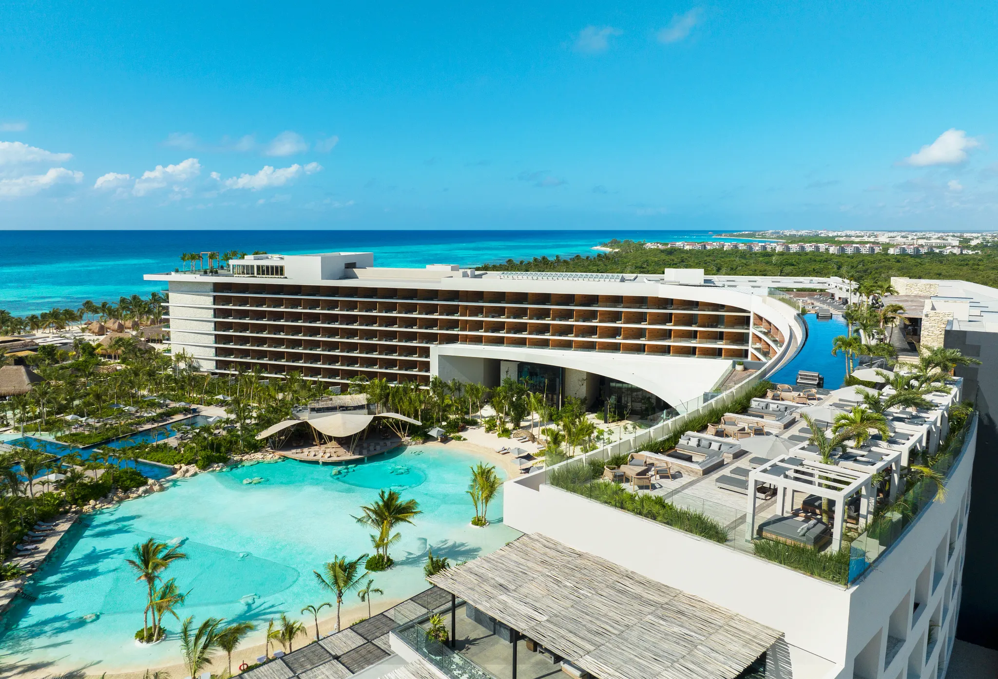 Aerial view of Secrets Moxché Playa Del Carmen resort with lagoon pools, oceanfront location, and modern architecture.