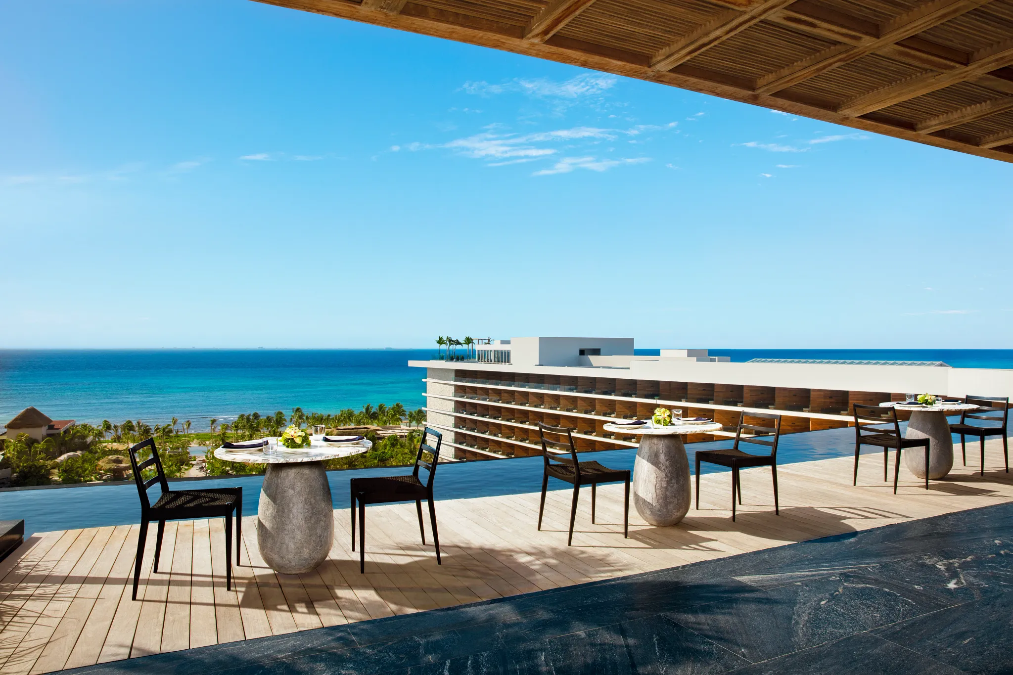 Rooftop dining terrace overlooking the Caribbean Sea at Secrets Moxché Playa Del Carmen luxury resort.